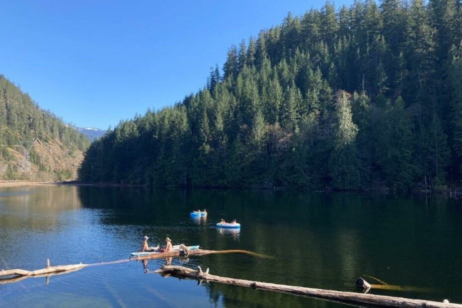 People floating on inflatables and paddleboards and doing some Brohm Lake fishing