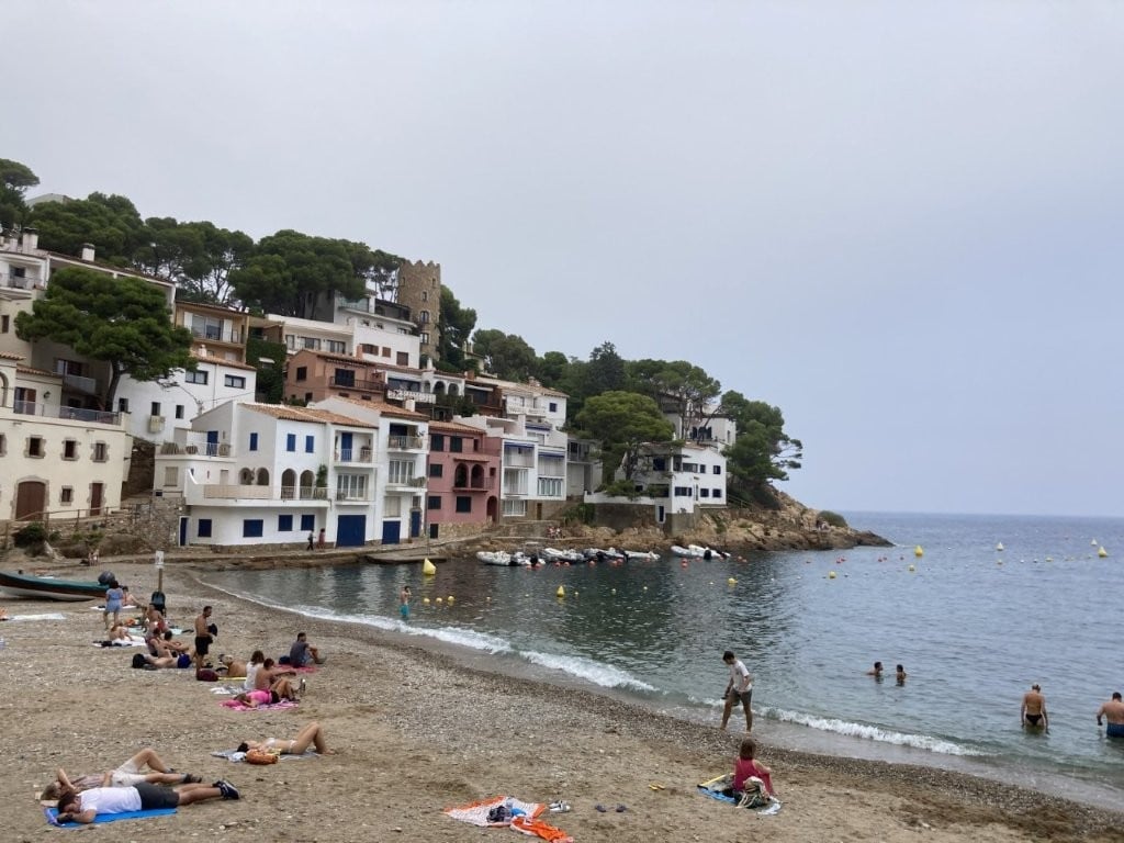 Rocky beach backed by small apartments