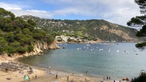 Beach in a small bay hemmed in by green hills in Begur Spain