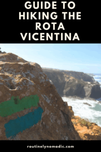 Hiking trail marker on a rock overlooking the ocean