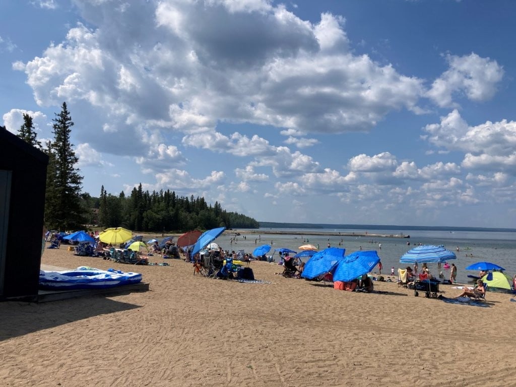 Waskesiu Lake main beach with lots of umbrellas