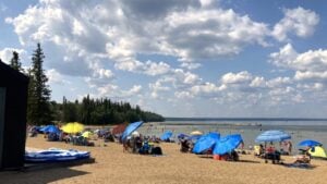 Waskesiu Lake Main Beach with umbrellas