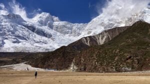 Hiker on a plateau backed by mountains