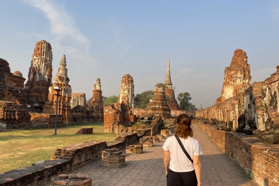 Woman walking in Thai ruins of Ayutthaya