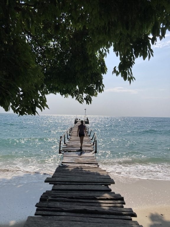 Woman walking out on a rickety wooden dock