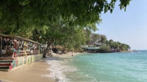 Colourful beach bar and small beach at high tide