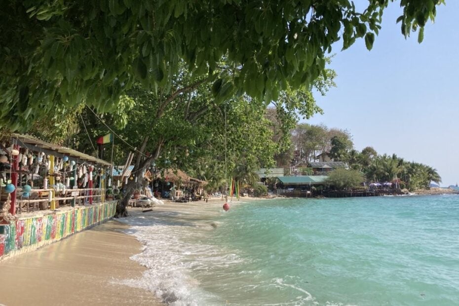Colourful beach bar and small beach at high tide