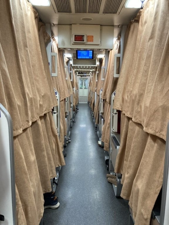 Aisle lined by curtain on a Thai train