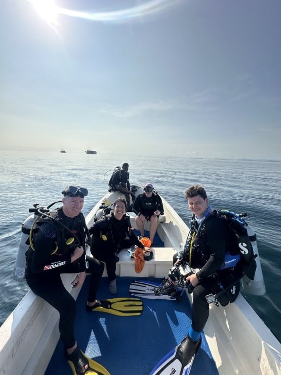Divers on a dinghy preparing to enter the water
