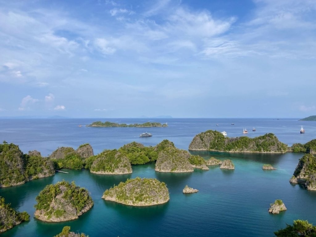Small green limestone islands in blue ocean