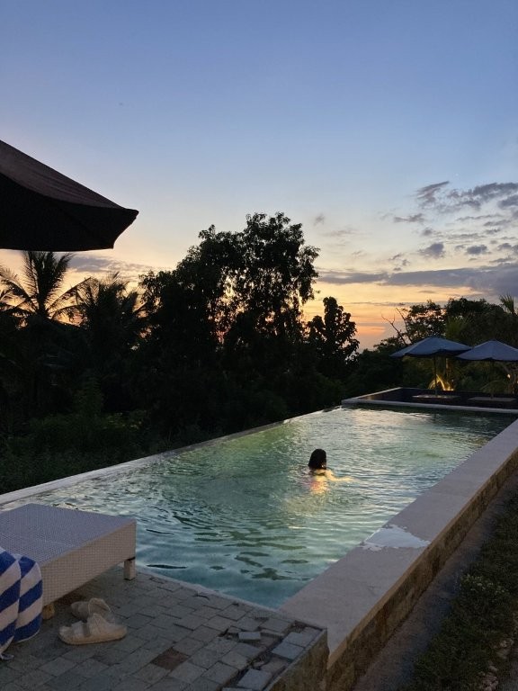 Woman swimming in a small pool at night