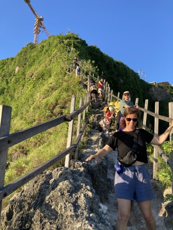 Queue of people coming down rocky stairs