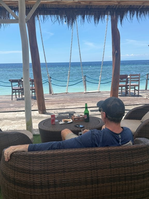 Man in restaurant overlooking the ocean