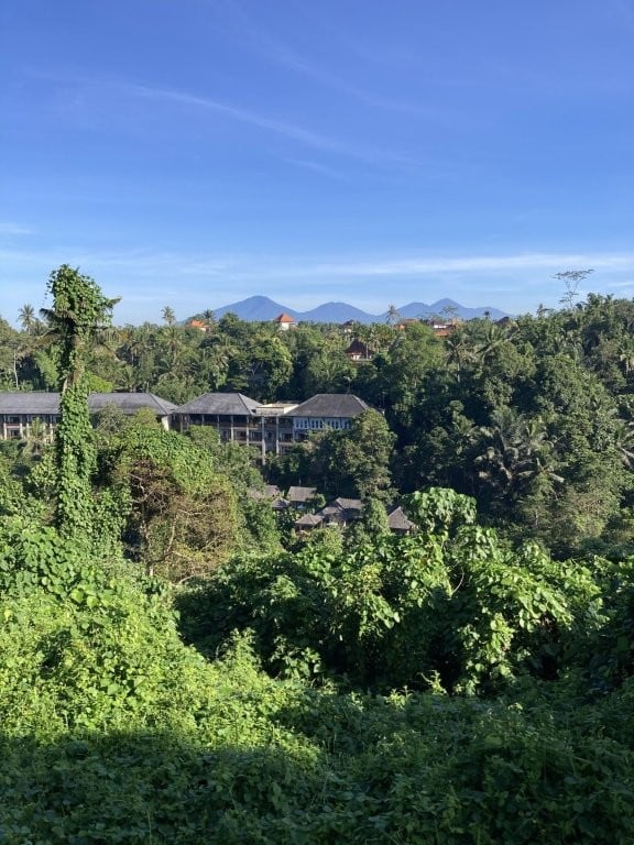 Hotel in jungle valley with volcanoes in background