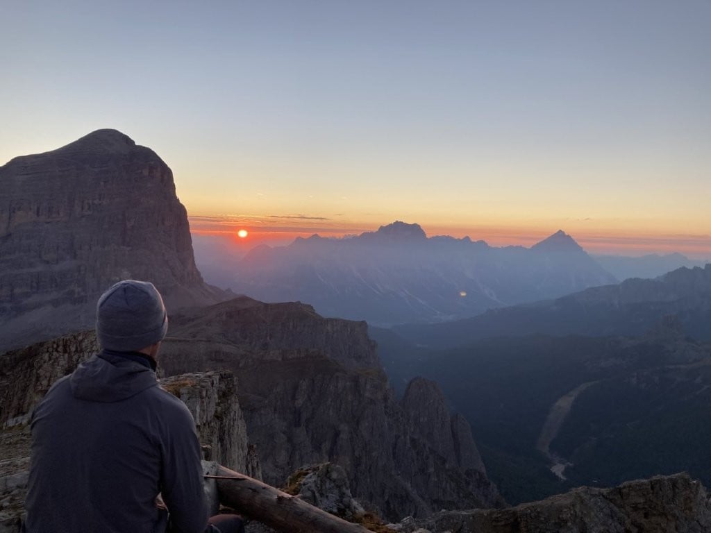 Man watching sunrise over the Dolomites on the Alta Via 1