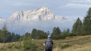 Hiker heading toward a cloudy mountain