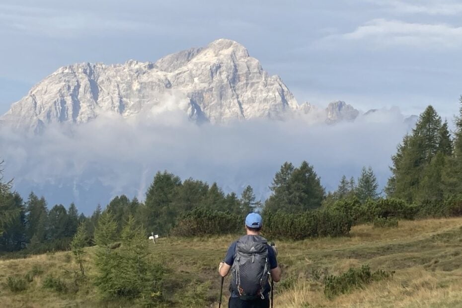 Hiker heading toward a cloudy mountain