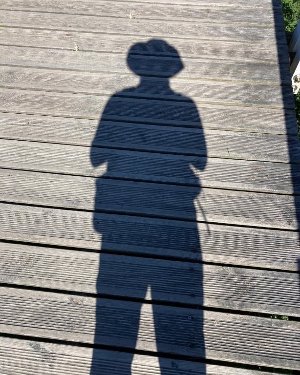 Shadow of a hiker on the boardwalk