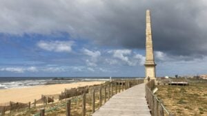 Beach boardwalk and stone spire