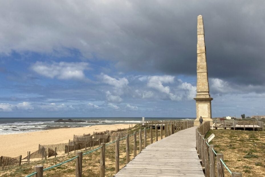 Beach boardwalk and stone spire