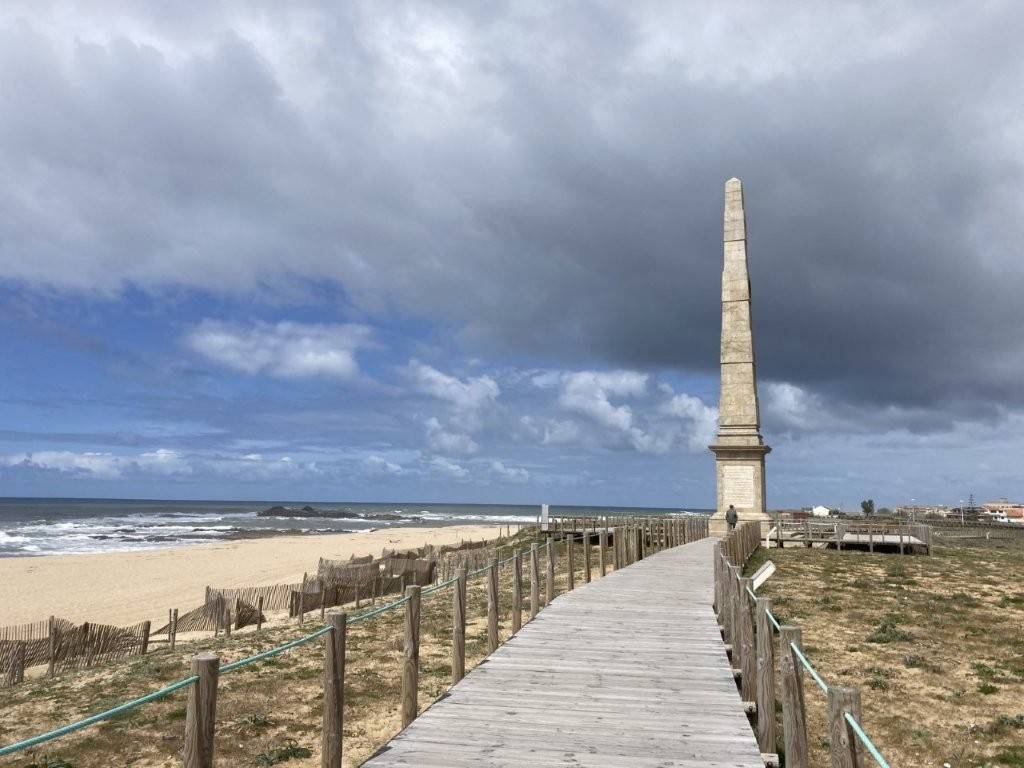Beach boardwalk and stone spire