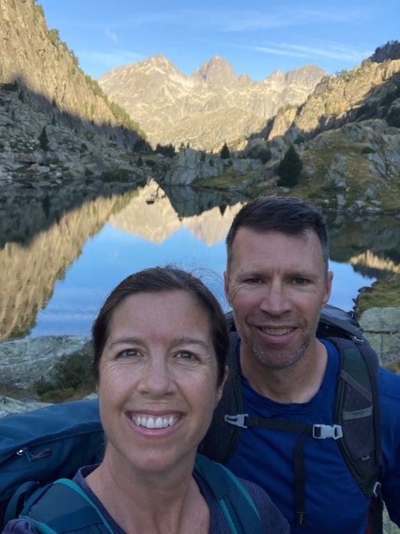 Couple in front of a reflective mountain lake