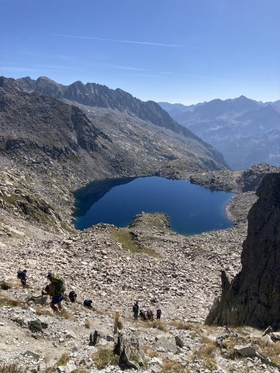 Man hiking down steep rocky mountain trail