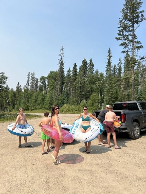 Family in parking lot preparing for a lazy river float