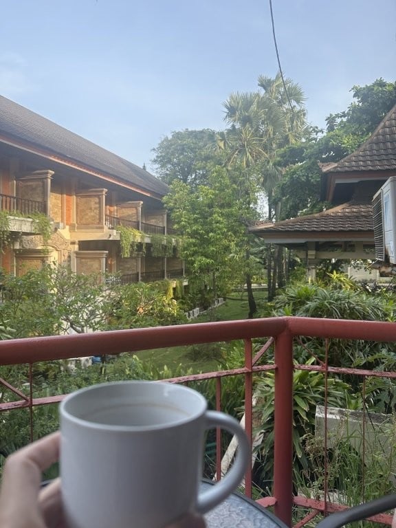 Cup of tea overlooking a green courtyard