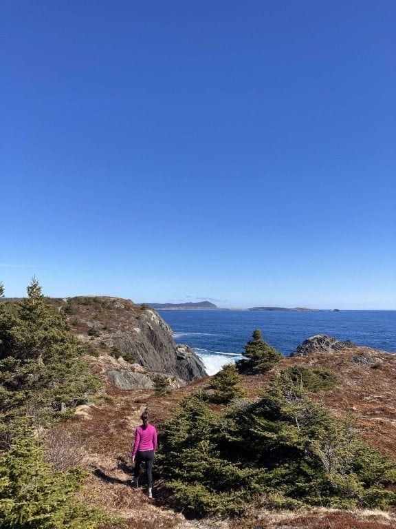 Woman hiking along the coast near St Johns Newfoundland