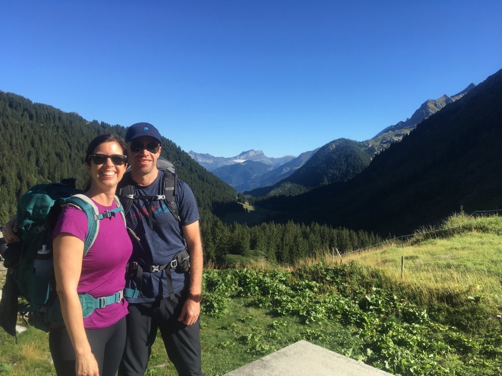 Couple selfie in front of lush green valley