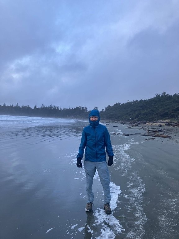 Man in rain gear on the beach in a storm