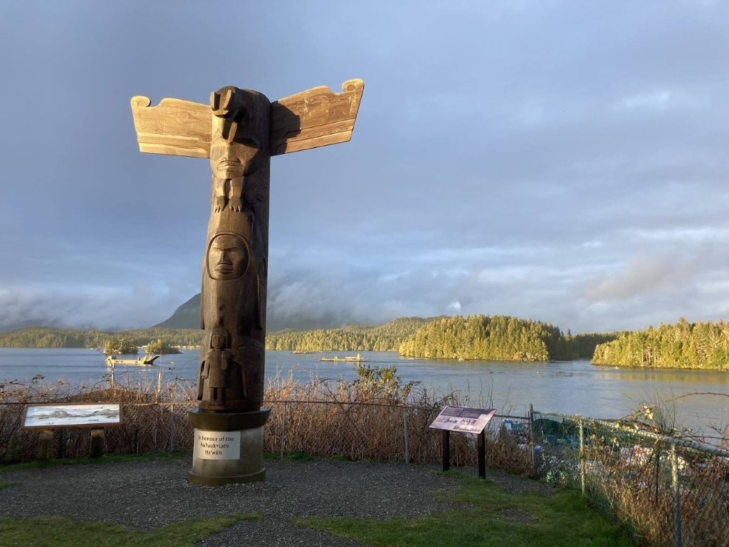 Totem pole overlooking Tofino harbour at sunset