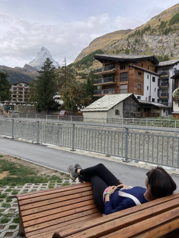 Woman relaxing on a bench in Zermatt