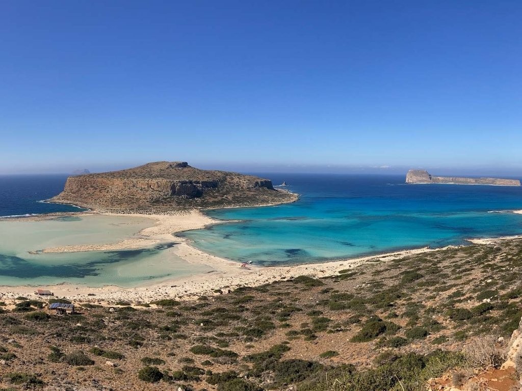 Long beach, narrow sand bar and dramatic rocky island