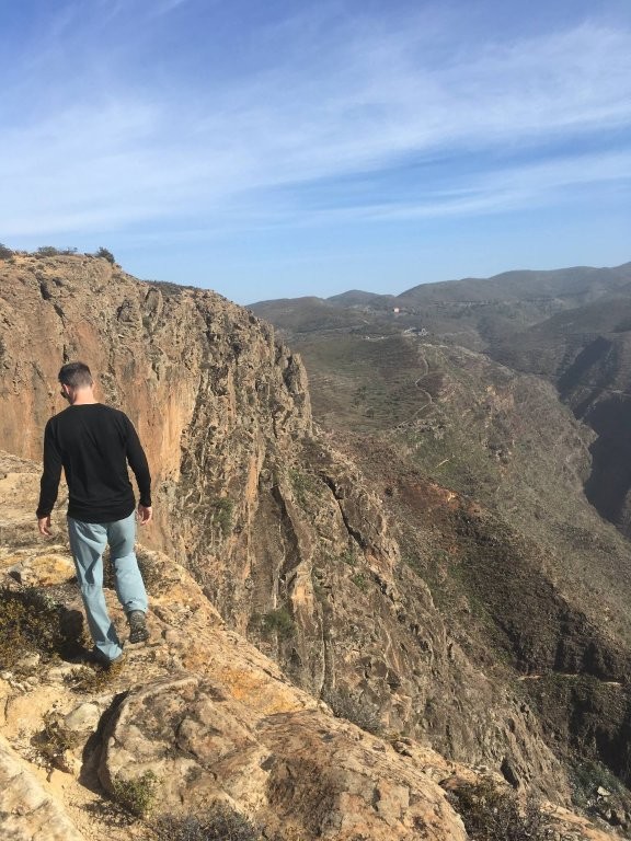 Man hiking on cliff edge in La Gomera