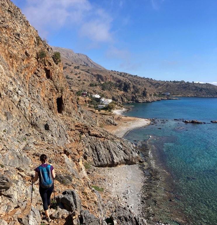 Woman hiking on rocky coastline