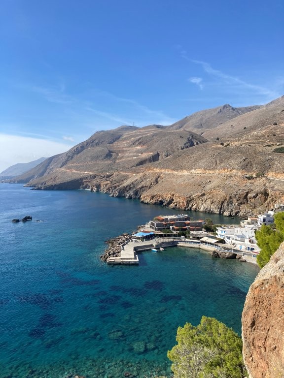 Greek village harbour in a blue water bay