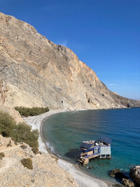 Floating restaurant in a rocky bay