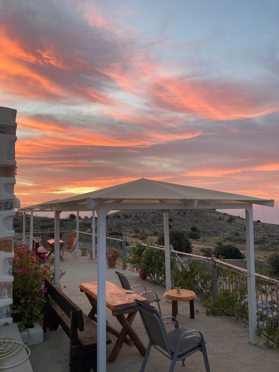 Pink and blue sunset over a Greek villa