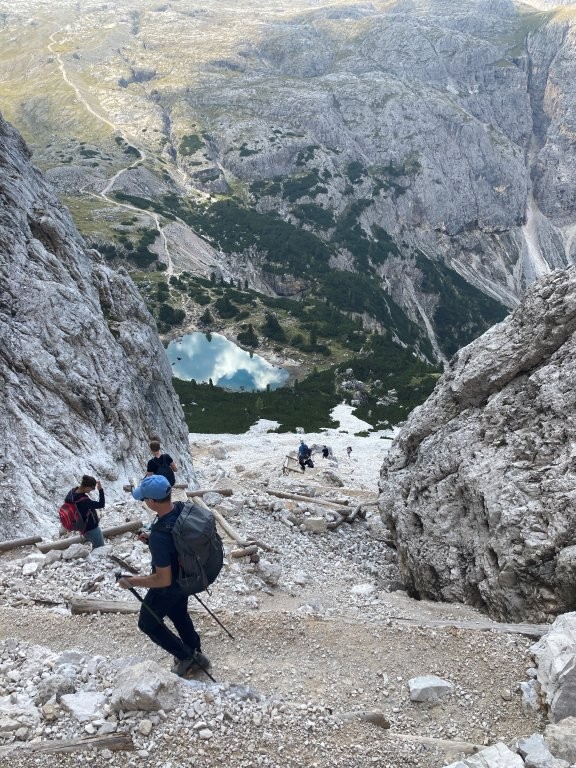 Hikers making their way down steep mountain pass
