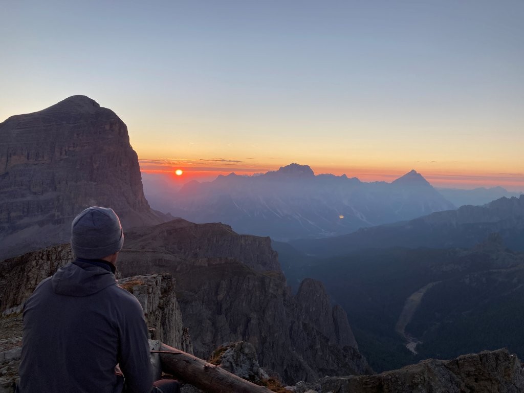 Man looking out at mountain sunrise