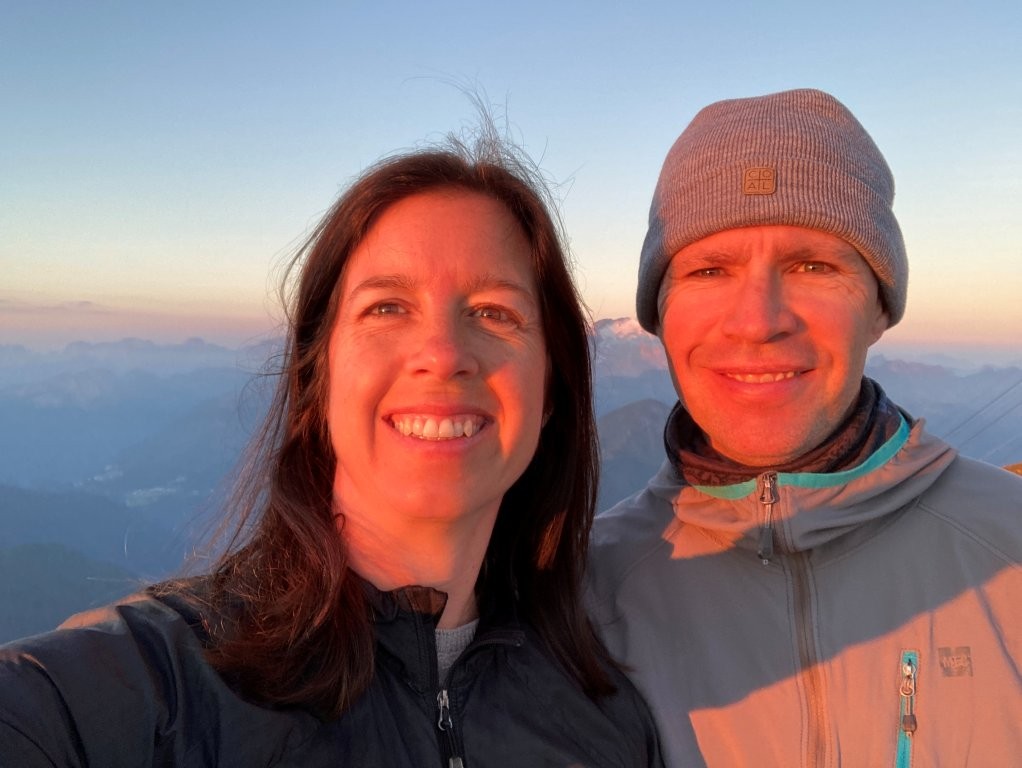 Couple selfie at sunrise with mountain background