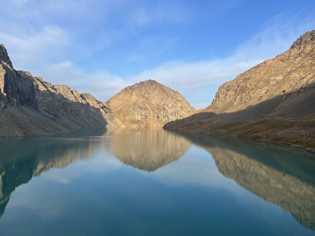 Reflective lake surrounded by mountains