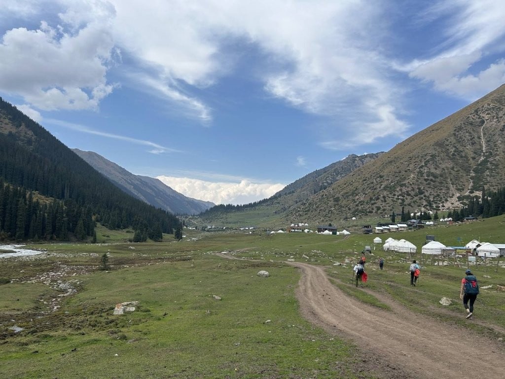 Hikers entering Altyn-Arashyn village in Kyrgyzstan