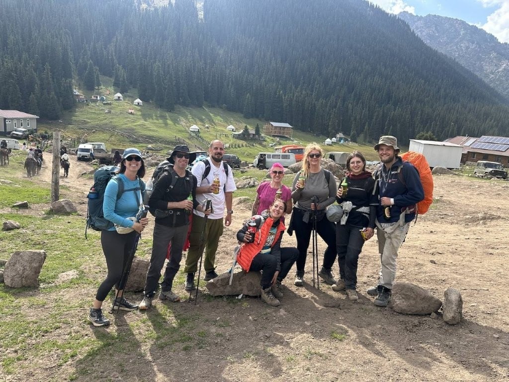 Group of hikers celebrating with beer