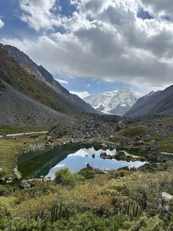 Reflective alpine lake in a mountain valley