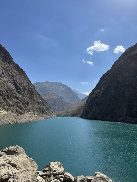 Calm lake surrounded by tall hills